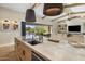 Kitchen island and countertops, showing seamless access through sliding glass doors to the pool and backyard at 20055 N 96Th Way, Scottsdale, AZ 85255