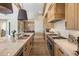 Modern kitchen with island, sleek appliances, and eat-in area with a table visible in the background at 20055 N 96Th Way, Scottsdale, AZ 85255