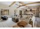 Open-concept living space with a large sectional sofa, wooden beams, and seamless access to the kitchen at 20055 N 96Th Way, Scottsdale, AZ 85255