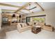 Spacious living area featuring a modern kitchen, large sectional, and seamless indoor-outdoor flow at 20055 N 96Th Way, Scottsdale, AZ 85255
