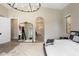 Open main bedroom with views into the bathroom and a stylish mirror adding depth to the room at 20055 N 96Th Way, Scottsdale, AZ 85255