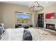 Bright main bedroom with large windows providing scenic views, inviting seating, and a fireplace at 20055 N 96Th Way, Scottsdale, AZ 85255