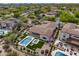 A beautiful backyard featuring a sparkling pool, spa, lounge chairs, and outdoor kitchen perfect for entertaining at 20055 N 96Th Way, Scottsdale, AZ 85255