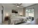 Bright bedroom with a ceiling fan, neutral decor, and sliding glass door to patio at 2020 W Union Hills Dr # 110, Phoenix, AZ 85027