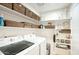 Functional laundry room with ample shelving and storage, plus modern washer and dryer at 2020 W Union Hills Dr # 110, Phoenix, AZ 85027