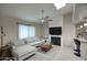 Bright living room with a fireplace, ceiling fan, and comfortable white sectional sofa at 2020 W Union Hills Dr # 110, Phoenix, AZ 85027