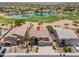 Aerial view of the home with a lake view, showcasing the property's location on a golf course at 21841 N Ingram Ct, Maricopa, AZ 85138
