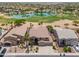 Gorgeous aerial view of home showcasing landscaping, serene lake and surrounding golf course at 21841 N Ingram Ct, Maricopa, AZ 85138