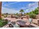 Beautiful outdoor brick patio area with a built in fireplace and comfortable seating, perfect for entertaining at 21841 N Ingram Ct, Maricopa, AZ 85138