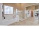 A well-lit bathroom features a separate tub and glass-enclosed shower offering a relaxing and functional space at 21841 N Ingram Ct, Maricopa, AZ 85138