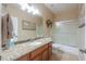 Bathroom with granite countertops, decorative backsplash, and shower/tub combo at 21841 N Ingram Ct, Maricopa, AZ 85138