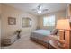 A cozy bedroom with neutral tones featuring a decorative mirror, plush carpet, and comfortable furnishings at 21841 N Ingram Ct, Maricopa, AZ 85138