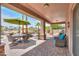 Covered outdoor patio and entertainment area with fireplace and scenic backyard views at 21841 N Ingram Ct, Maricopa, AZ 85138