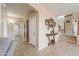 Inviting entryway with tiled floors, decorative console table, and staircase view at 21841 N Ingram Ct, Maricopa, AZ 85138
