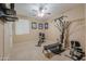 Carpeted exercise room with a ceiling fan and various workout machines at 21841 N Ingram Ct, Maricopa, AZ 85138