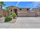Inviting two-story home showcasing a three-car garage, stucco siding and well maintained landscaping at 21841 N Ingram Ct, Maricopa, AZ 85138