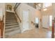 Grand foyer with staircase, tiled floor, and an elegant front door at 21841 N Ingram Ct, Maricopa, AZ 85138