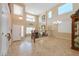 Bright foyer with tile flooring, tall ceilings, clerestory windows and decorative staircase railing at 21841 N Ingram Ct, Maricopa, AZ 85138