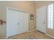 Hallway with tile flooring, storage closet and entry door with side lights at 21841 N Ingram Ct, Maricopa, AZ 85138