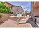 Backyard with a built in hot tub, paver patio, brick walls, and an outdoor grill at 21841 N Ingram Ct, Maricopa, AZ 85138