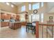 Bright, open kitchen with granite counters, wooden cabinets, and a breakfast nook with natural light at 21841 N Ingram Ct, Maricopa, AZ 85138