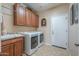 Functional laundry room with ample cabinet space, sink, and modern washer/dryer at 21841 N Ingram Ct, Maricopa, AZ 85138