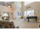 Grand living room boasting high ceilings, fireplace, piano, and elegant decor at 21841 N Ingram Ct, Maricopa, AZ 85138