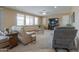 Comfortable living room with plush seating, a ceiling fan, and a modern entertainment center at 21841 N Ingram Ct, Maricopa, AZ 85138