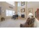 Grand living room featuring a fireplace, piano, tall ceilings and lots of natural light at 21841 N Ingram Ct, Maricopa, AZ 85138