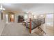 Upstairs loft area with comfortable seating, TV, and wrought iron railing at 21841 N Ingram Ct, Maricopa, AZ 85138