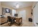 Home office with neutral walls, tile flooring, a modern desk setup and white closet doors at 21841 N Ingram Ct, Maricopa, AZ 85138
