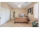 Home office with neutral walls, tile flooring, and a modern desk setup with storage at 21841 N Ingram Ct, Maricopa, AZ 85138