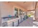 This luxury home has a built-in outdoor kitchen with a granite counter, stainless steel grill and sink at 21841 N Ingram Ct, Maricopa, AZ 85138