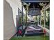 Backyard patio featuring covered porch swing, tv, putting green and outdoor kitchen area at 226 E Markwood Dr, Chandler, AZ 85286