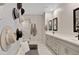 Stylized bathroom featuring decorative hats, a bench, double vanity and glass-enclosed shower at 226 E Markwood Dr, Chandler, AZ 85286