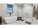 This bathroom features a freestanding tub, glass enclosed shower and neutral colored walls at 226 E Markwood Dr, Chandler, AZ 85286