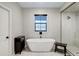 This bathroom features a freestanding tub, glass enclosed shower and dark fixtures at 226 E Markwood Dr, Chandler, AZ 85286