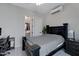Cozy bedroom with a ceiling fan, mini-split AC, and ensuite bath featuring a gray color palette at 226 E Markwood Dr, Chandler, AZ 85286