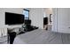 Bedroom with an ensuite bathroom, modern entertainment setup, and dedicated workspace at 226 E Markwood Dr, Chandler, AZ 85286