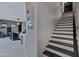 Entryway featuring stairs and view into the kitchen and living space with bar seating and modern design at 226 E Markwood Dr, Chandler, AZ 85286