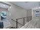 Upstairs hallway with wood flooring, a cable railing and views into the bedroom at 226 E Markwood Dr, Chandler, AZ 85286