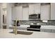 Close-up of a well-appointed kitchen featuring stainless steel appliances and modern finishes at 226 E Markwood Dr, Chandler, AZ 85286