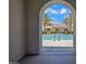 View of a community pool with refreshing water, seen through an arched entryway with palm trees in the background at 226 E Markwood Dr, Chandler, AZ 85286