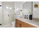 Bathroom showcasing a glass shower, white marble counters and wood cabinets, bathed in natural light at 24645 N 117Th St, Scottsdale, AZ 85255