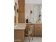 This bathroom features wood cabinetry, modern lighting fixtures, and a vanity area at 24645 N 117Th St, Scottsdale, AZ 85255