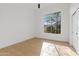 Bright bedroom with wood floors, a large window, and white walls at 24645 N 117Th St, Scottsdale, AZ 85255