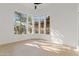 An empty, light-filled bedroom featuring a large window with neighborhood views and wood floors at 24645 N 117Th St, Scottsdale, AZ 85255