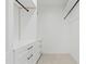 A walk-in closet with white shelving and drawers, and minimalist black hardware at 24645 N 117Th St, Scottsdale, AZ 85255