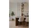 Bright kitchen with a light wood floor, kitchen island with pendant light and a basket with a small tree at 24645 N 117Th St, Scottsdale, AZ 85255