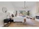 Bright, spacious main bedroom with large windows, modern decor and views of the resort-style backyard at 24645 N 117Th St, Scottsdale, AZ 85255